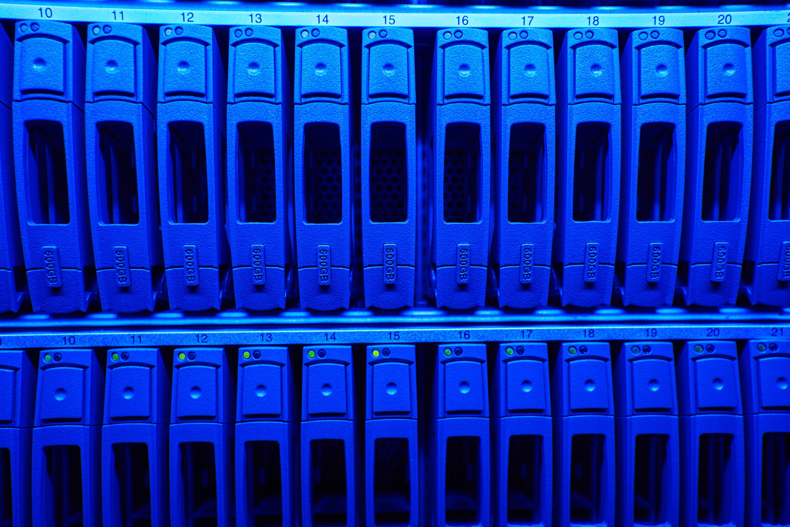 Close up image a lot of different HDD disks with yellow indicators