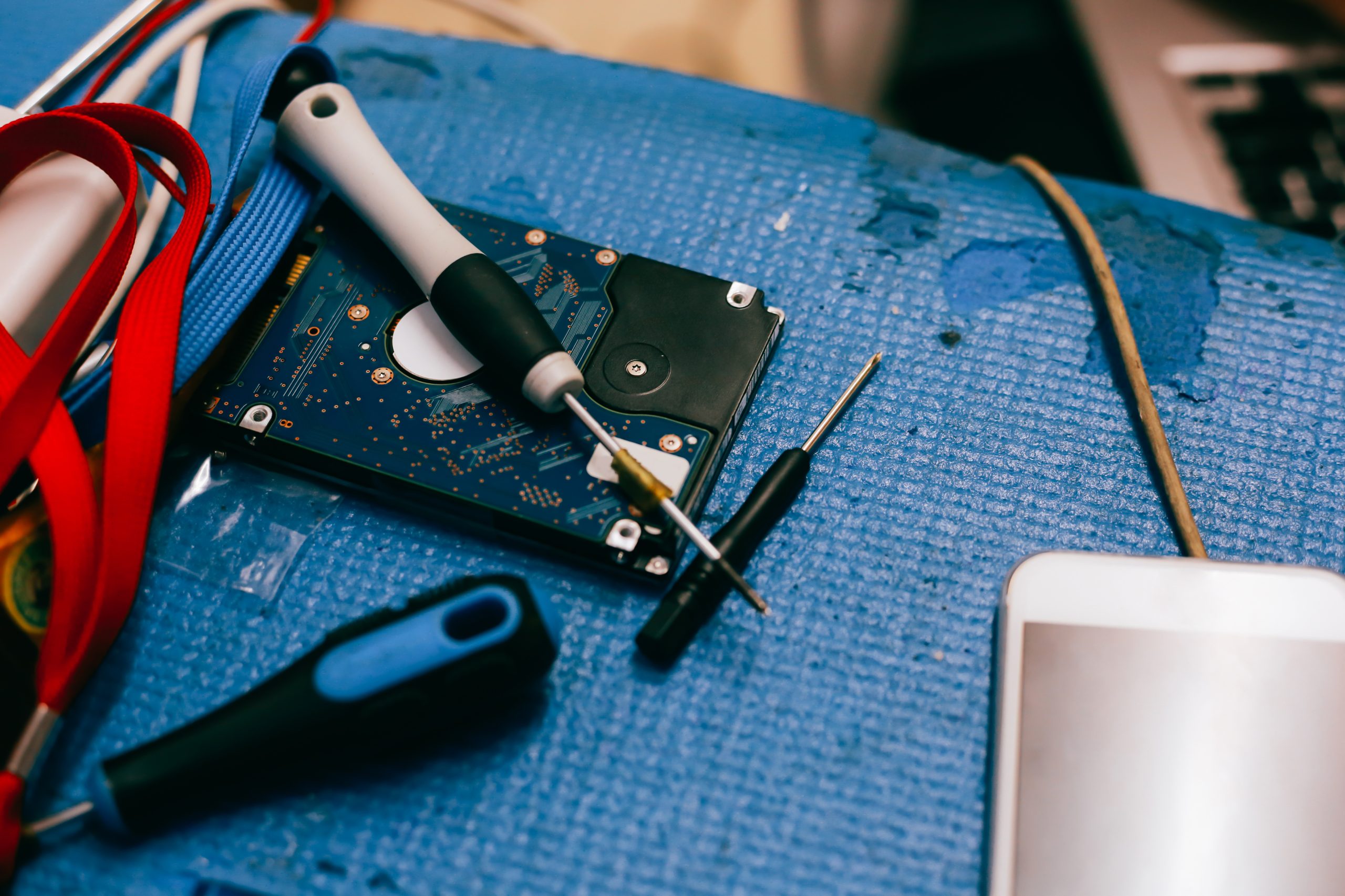 Hard drive being pulled out from computer pc for repair and data backup recovery process